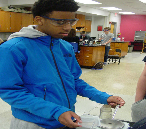 Laprell S. measures the correct amout of iron on the balance